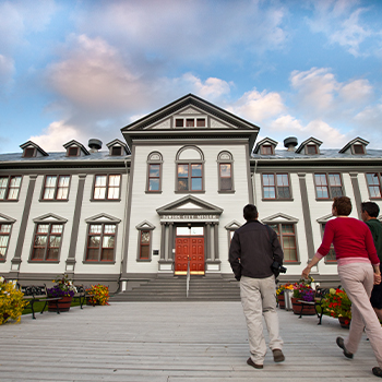 People walking up to the Dawson City Museum.